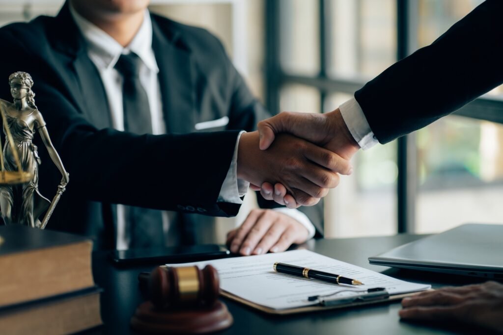 Attorney shaking hands with a client after a successful real estate closing